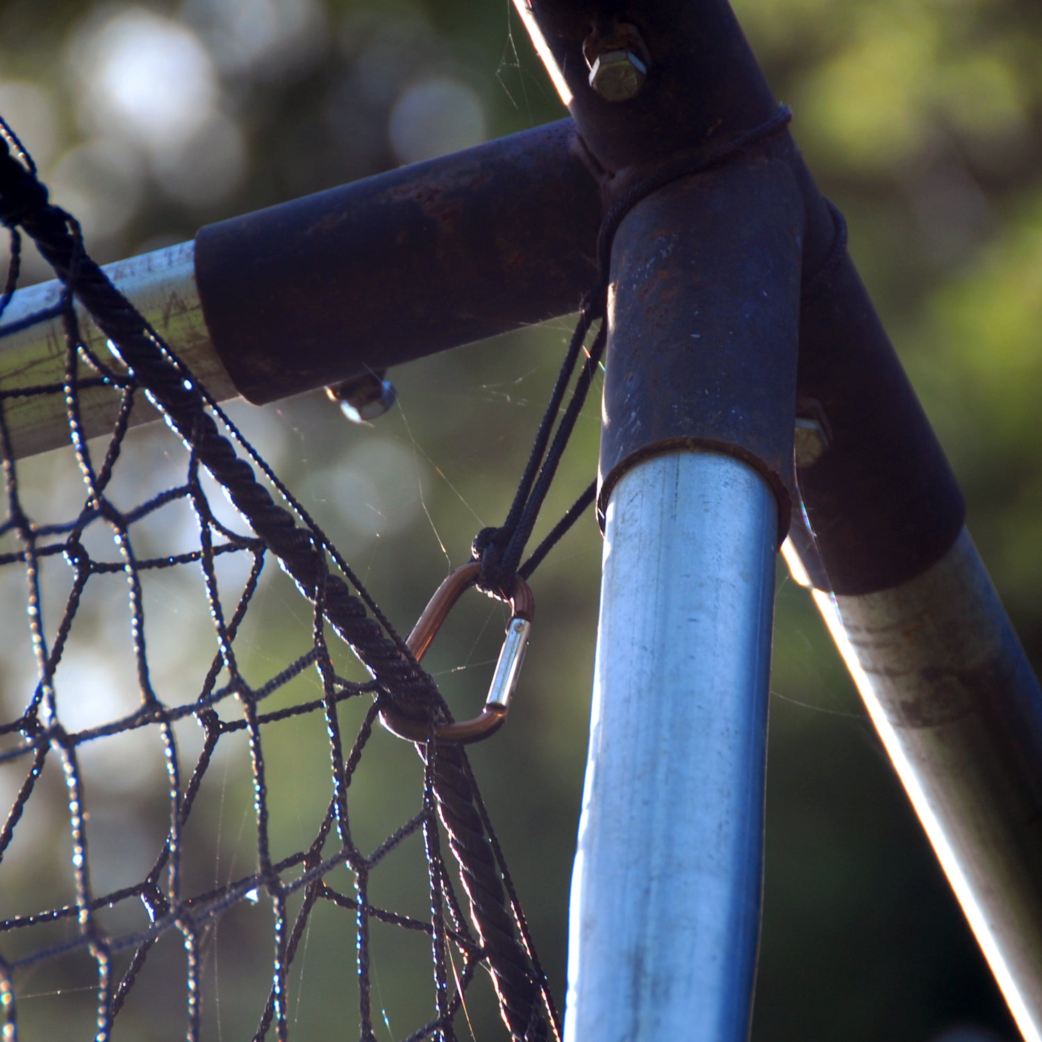 Net Hanger and carabiner securing net to poles